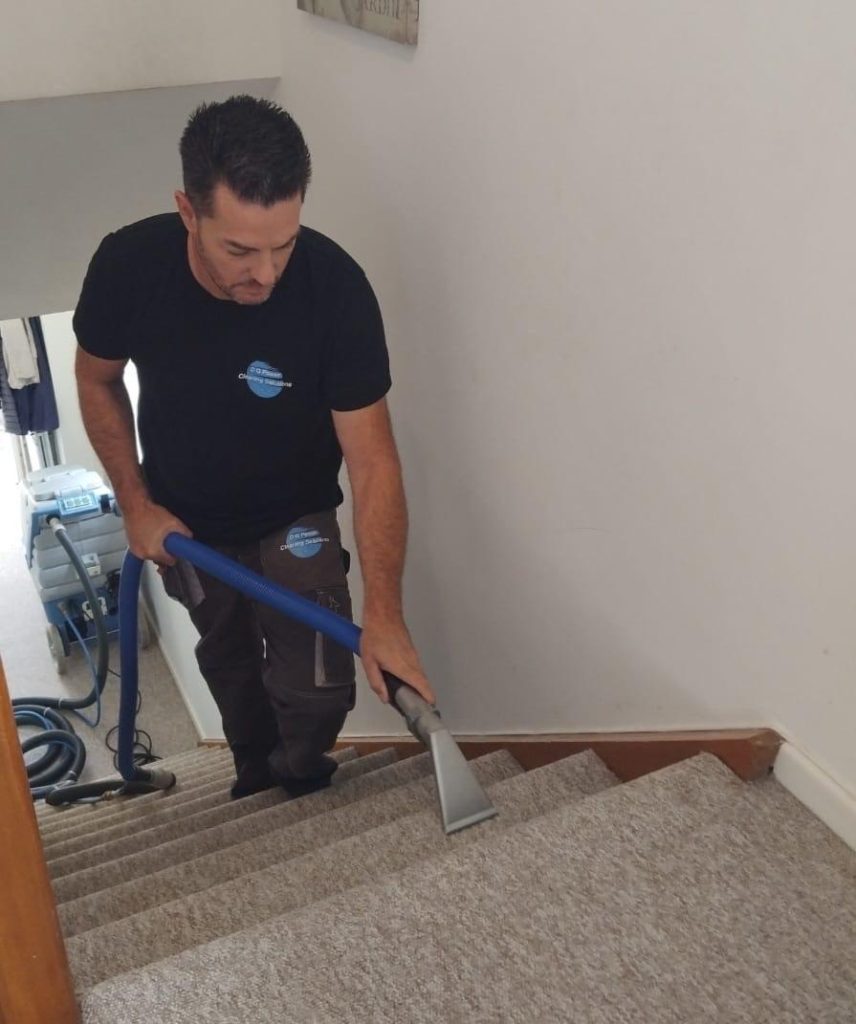 Danilo Garofoli cleaning a stair carpet with hot water extraction in Seaton, Devon