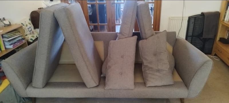 Sofa cushions standing upright to dry after upholstery cleaning in Seaton