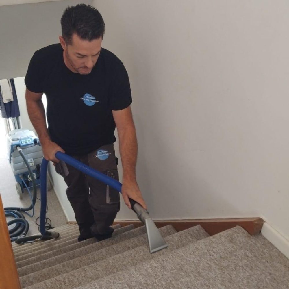 Danilo Garofoli cleaning a stair carpet with hot water extraction in Seaton, Devon